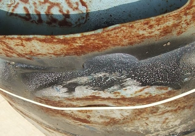 Severely dented propane cylinder